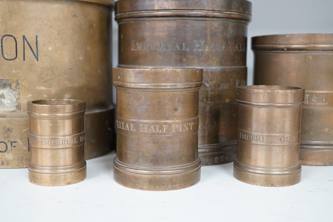 A set of seven early 20th century County of Fife official measures, comprising; a standard gallon, diameter 19.5cm, height 18.5cm, Imperial half gallon, Imperial quart, Imperial pint, Imperial half pint, Imperial gill, I